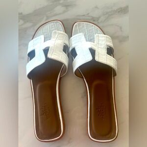 Brand new H slippers bought at a Tuscany market in Italy.